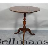 A late George III mahogany tripod table, on turned column and three downswept supports,
