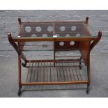 A mid-20th century teak and glass serving trolley, with split levels and slatted undertier,