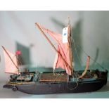 An early 20th century wooden model of a Thames Barge, 99cm wide x 64cm high.