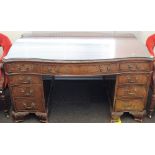 An 18th century style mahogany pedestal partners desk of serpentine outline,