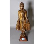 An early 20th century painted hardwood figure of a Thai Buddha, 47cm high.