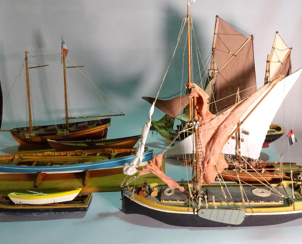 A group of eight modern wooden models of boats and sailing ships, the largest 60cm wide x 56cm high.