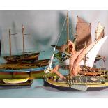 A group of eight modern wooden models of boats and sailing ships, the largest 60cm wide x 56cm high.