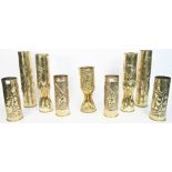 A pair of WWI brass trench art shell cases formed as vases, each dated 1916 and embossed with flora,