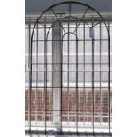 Wrought iron window frames, early 20th century, the first of arched, segmented form, 171cm high,