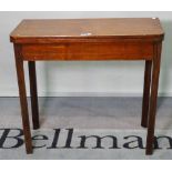 A late George III mahogany foldover tea table, on fluted block supports, 82cm wide x 73cm high.