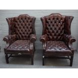 A pair of early 18th century style shaped wing back armchairs,