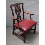A George III Chippendale style carved mahogany openarm elbow chair,