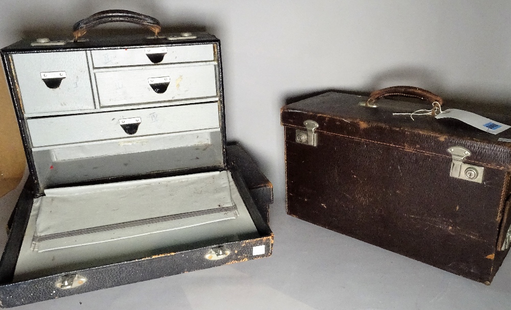 A group of three modern travelling cases with fitted drawers, the largest 46cm wide x 27cm high.