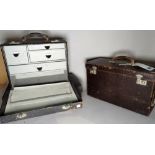 A group of three modern travelling cases with fitted drawers, the largest 46cm wide x 27cm high.