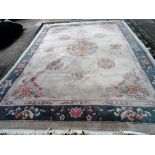 A Chinese carpet with beige field and floral roundels, 375cm x 280cm.
