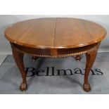 A Victorian mahogany circular extending dining table, on ball and claw supports, one extra leaf,