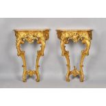 A pair of late 18th century French consoles, each with serpentine marble top,