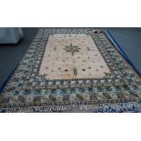 A Moroccan carpet, African, the pink field with a central medallion, minor motifs,