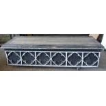 A Grey painted rectangular plinth with Gothic quatrefoil decoration, 232cm wide x 53cm high.