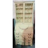 A modern cream painted bureau bookcase, the glazed doors over four long graduated drawers,