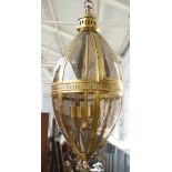 A modern gilt metal lantern of ovoid form, with glazed panels,