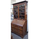 A George III mahogany bureau bookcase, the pair of glazed doors over fitted interior,