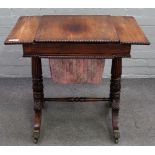 A Regency rosewood games/sewing table, on reeded columns and four downswept supports,
