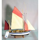 A modern wooden model of a sailing boat, 53cm wide x 69cm high.