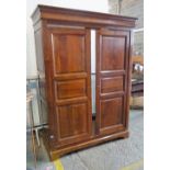 A modern French fruitwood two door armoire.