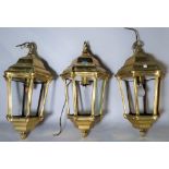 A group of three modern brass octagonal hall lanterns, 60cm high.