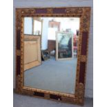 A late 20th century Italian parcel gilt scarlet painted rectangular wall mirror, with moulded frame,