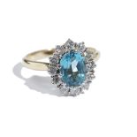 An 18 ct gold, blue topaz and diamond oval cluster ring,