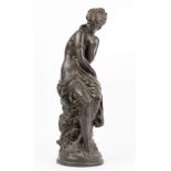 After Moreau, a modern composite bronze female figure, partially clothed and seated on a rock,