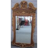 A George II style parcel gilt walnut pier glass, with swan neck cornice and bevelled plate,