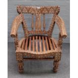 An early 20th century Indian hardwood open armchair, with extensive bone inlay,