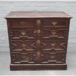 A Charles II oak chest of four long geometric drawers, 104cm wide x 98cm high.