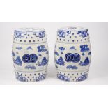 A pair of modern Chinese style blue and white garden seats, each decorated with landscape scenes,