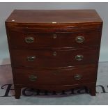 A late George III mahogany bowfront chest, the brushing slide over three long drawers,