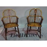 A pair of reproduction ash and elm Windsor elbow chairs, with pierced splats,