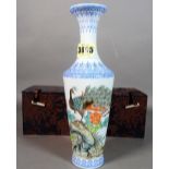 A modern Chinese porcelain vase of tapering form, decorated with a peacock, 26cm high, (boxed).