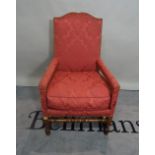 A 19th century mahogany framed highback open armchair on ring turned supports,