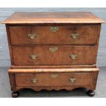 A George I walnut chest on stand, the pair of drawers over a single drawer base, on bun feet,