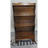 A modern stained beech waterfall bookcase, the single drawer base on bracket feet,