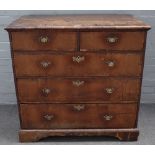 A George I crossbanded walnut chest, of two short and three long graduated drawers on bracket feet,