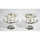 A pair of plated twin handled campana shaped wine coolers, having decorated wide rims.