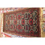 A Belouche rug, the shaped field with four diamonds, a 3-line and leaf border, 145cm x 85cm.