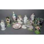 A group of eleven various Staffordshire pottery figures and groups including a Tithe Pig group and