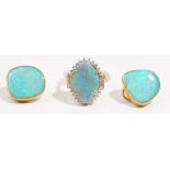 A precious yellow metal opal and diamond-set dress ring The precious opal claw-set to a surround of