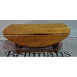 A modern oak drop flap oval coffee table, 122cm wide x 47cm high,