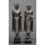 A modern pair of south east Asian hardwood Buddhas, on square ebonised plinths,