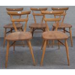Ercol; a set of five beech and elm green dot stacking chairs, 39cm wide x 76cm high.