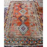 A Kazakh rug, Caucasian, the madder field with four hooked diamonds,