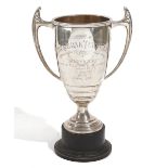 A silver twin handled trophy cup, engraved 'The Perak Turf Club', height 24cm, Birmingham 1953,