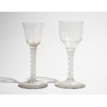 Two opaque twist wine glasses, circa 1765, the taller with moulded ogee bowl,